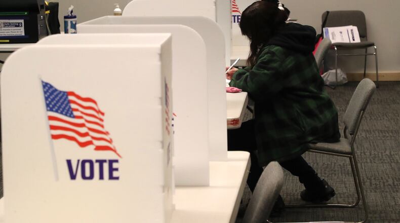 Voters cast ballots at the Clark County Heritage Center, where it’s been steady but not too busy Tuesday. BILL LACKEY/STAFF