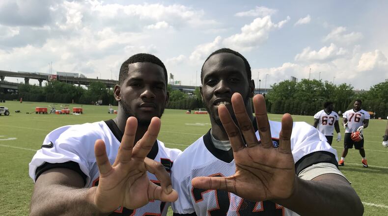New Cincinnati Bengals teammates Mark Walton (left) and Quinton Flowers flash the 305 area code from their hometown of Miami during last week’s rookie camp at Paul Brown Stadium.