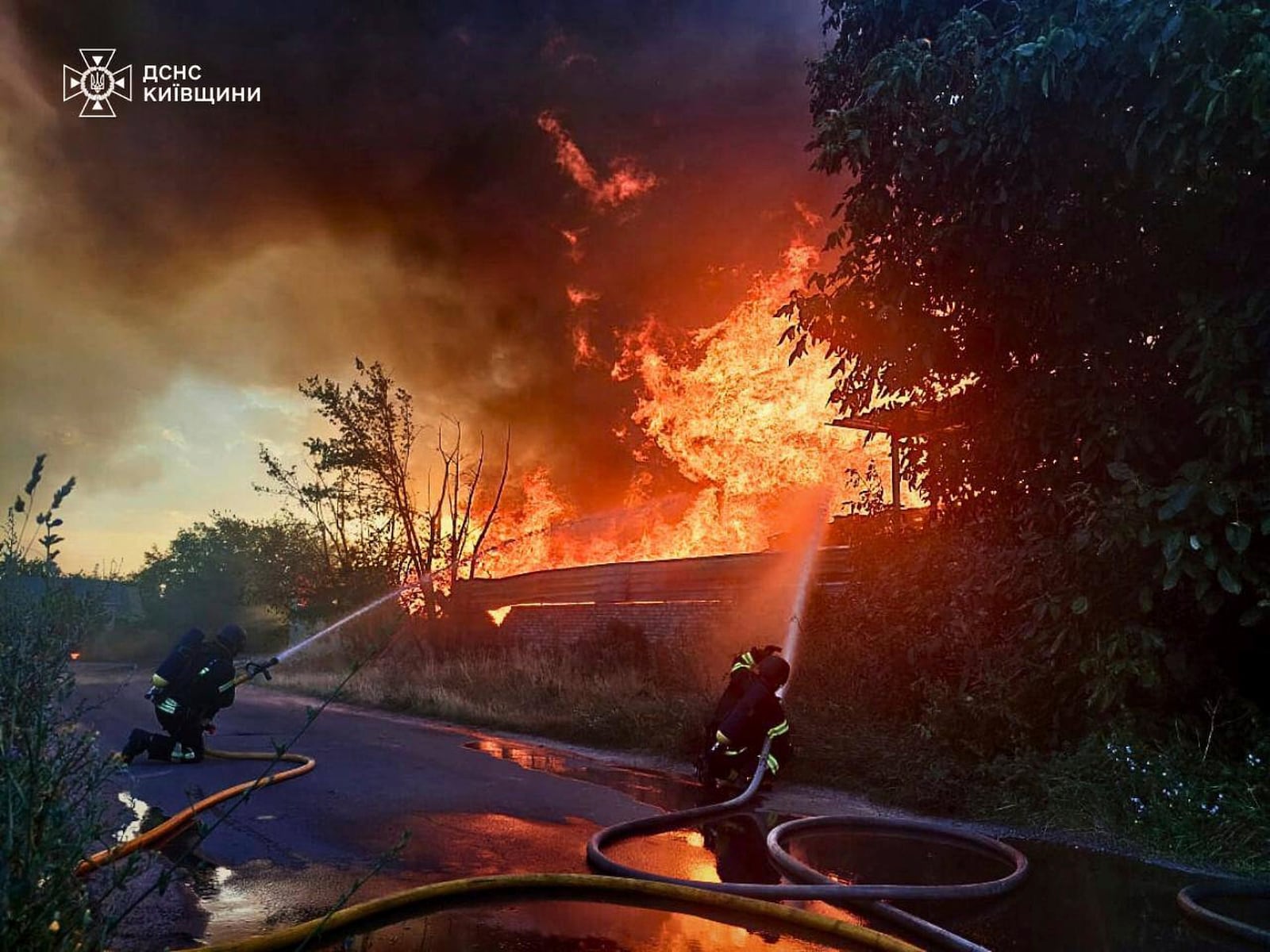 In this photo provided by the Ukrainian Emergency Service, firefighters put out the fire following a Russian attack in Kyiv region, Ukraine, Wednesday, July 9, 2025. (Ukrainian Emergency Service via AP)