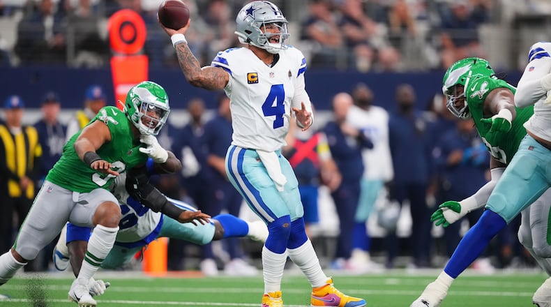 Dallas Cowboys quarterback Dak Prescott (4) throws a pass during the first half of an NFL football game against the Philadelphia Eagles, Sunday, Nov. 23, 2025, in Arlington, Texas. (AP Photo/Julio Cortez)