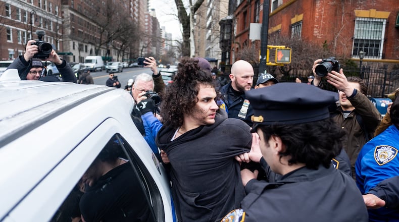 Police detain Emir Balat after he attempted to detonate an improvised explosive device during a counterprotest against far right influencer Jake Lang staging an anti-Islam protest outside Gracie Mansion, Saturday, March 7, 2026, in New York. (AP Photo/Julius Constantine Motal)