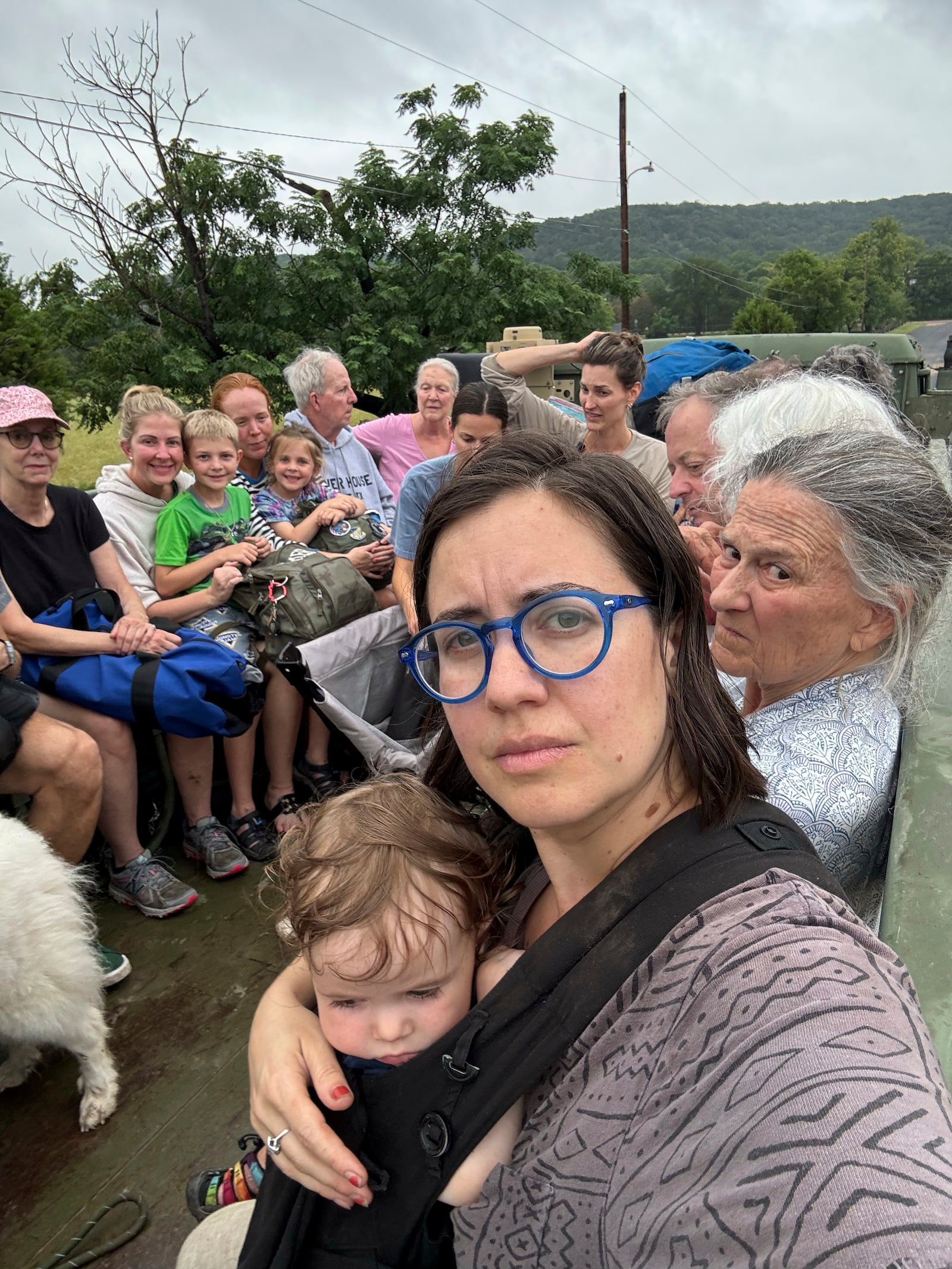 Shabd Simon-Alexander holds her one-year-old daughter, sitting next to Jane Towler, as they, Alden Towler, not pictured, and others are transported to a shelter from Hunt, Texas, at 6:31 p.m. on Friday, July 4, 2025. (Shabd Simon-Alexander via AP)