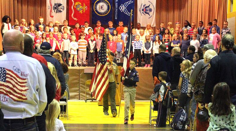 Northridge Elementary and Middle School students (left) Nick Curtis and Matthew Patch retire the colors after the annual Veterans Day program. JEFF GUERINI/STAFF