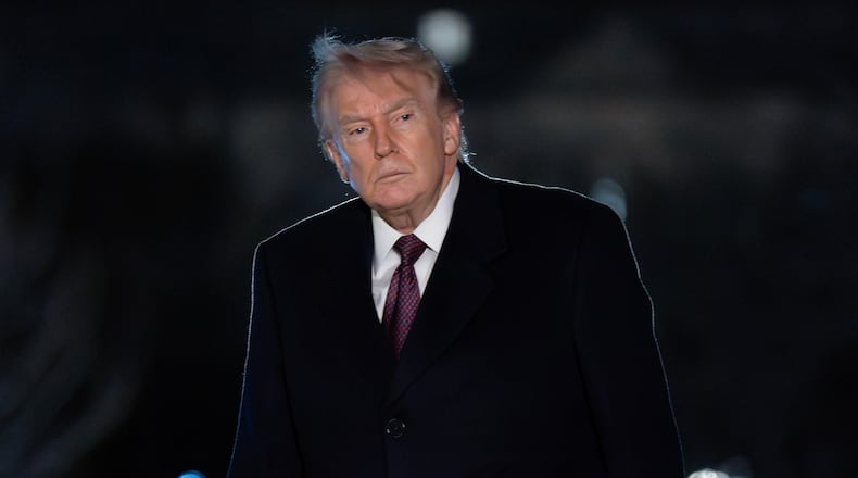 President Donald Trump walks on the South Lawn upon his arrival to the White House, Sunday, March 15, 2026, in Washington. (AP Photo/Jose Luis Magana)