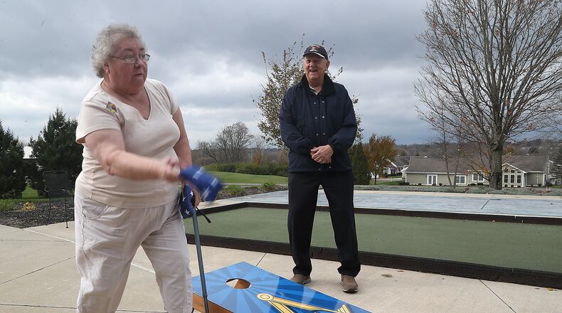 Betty Jane Gardner and Jim Suddath play corn hole at the Ohio Masonic Home. BILL LACKEY/STAFF