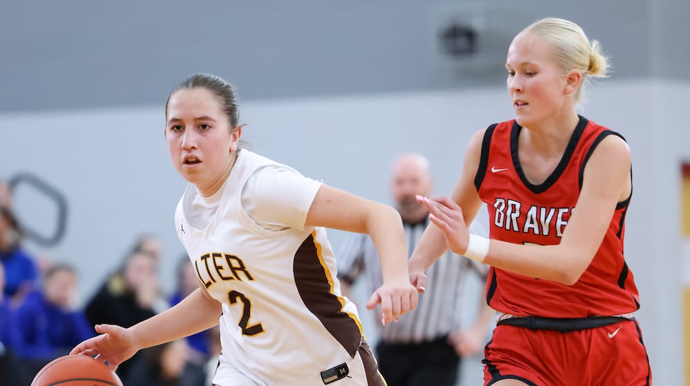 Alter senior guard Izzie Arcuri dribbles ahead of Cincinnati Indian Hill's Maddy Harris during a Division IV district final on Saturday, Feb. 28 at Troy High School's Trojan Activities Center. BRYANT BILLING / STAFF