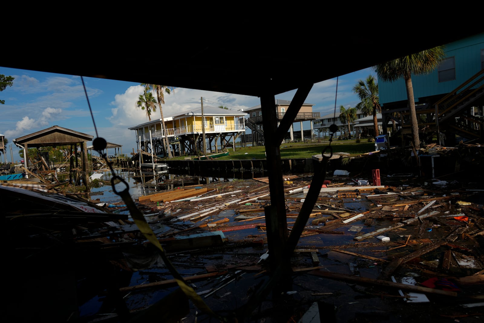 FILE - Debris from destroyed homes and structures floats in a canal in Horseshoe Beach, Fla., Aug. 31, 2023, one day after the passage of Hurricane Idalia. (AP Photo/Rebecca Blackwell, File)