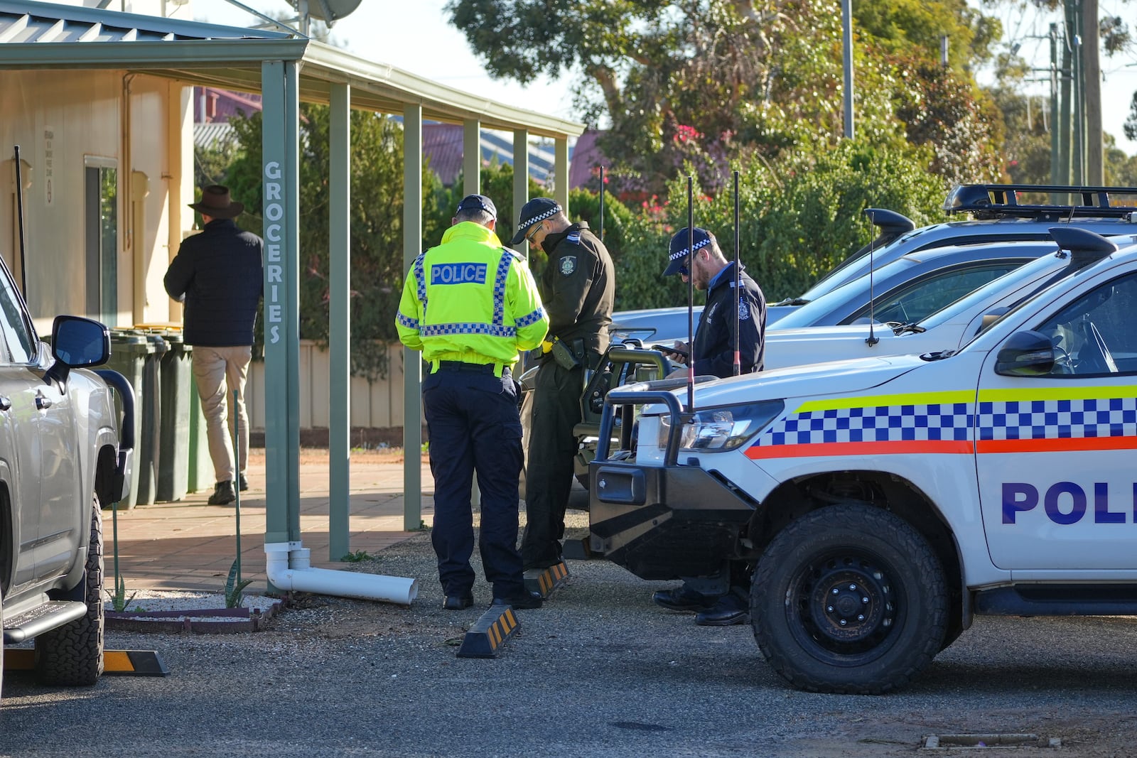 Police officers gather in Beacon, Western Australia, Friday, July 11, 2025, as they prepare to search for missing German backpacker Carolina Wilga. (ABC News via AP)