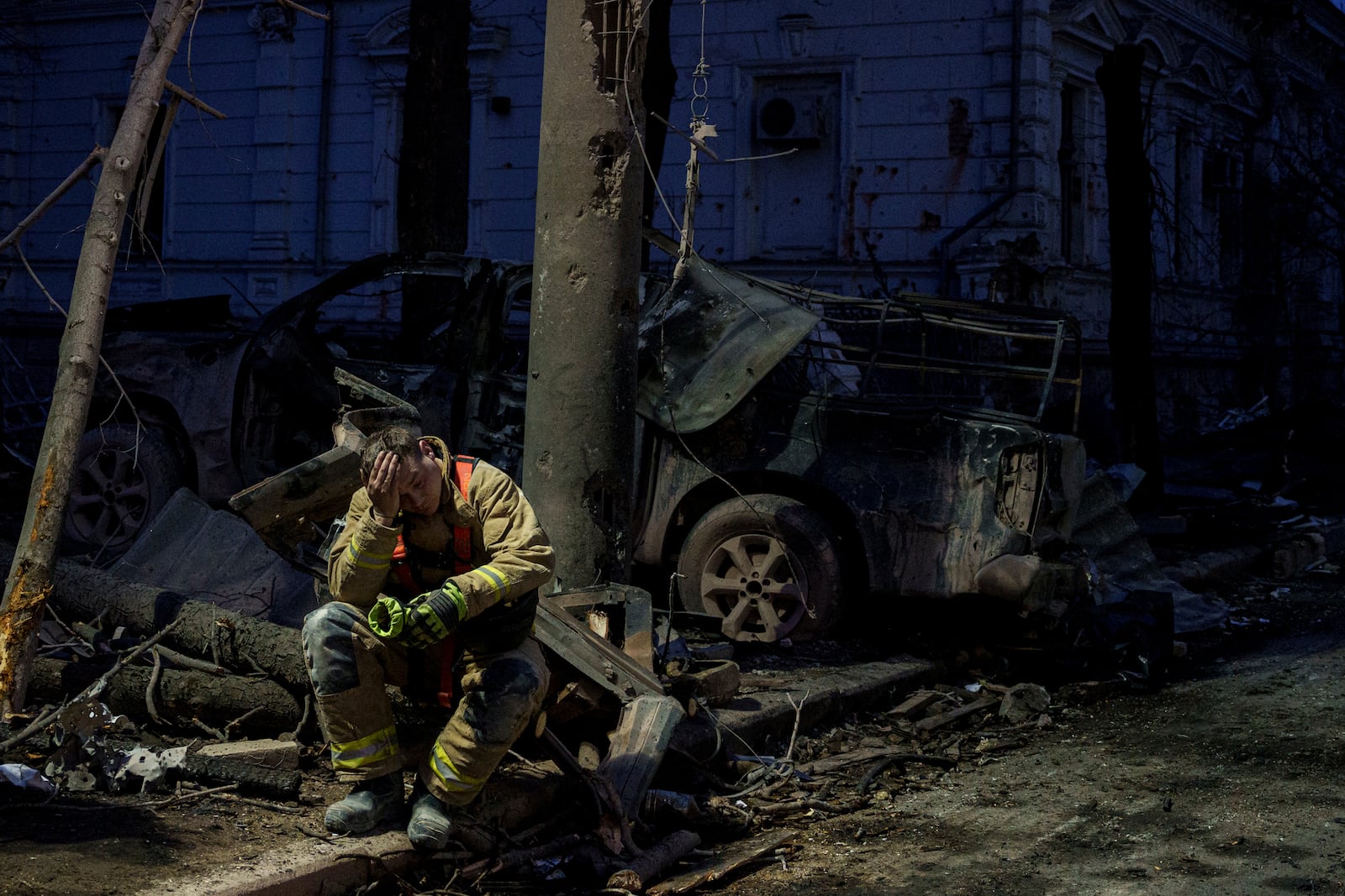 FILE= A rescue worker rests near university building destroyed by a Russian missile strike on Sumy, Ukraine, April 13, 2025. (AP Photo/Evgeniy Maloletka, File)