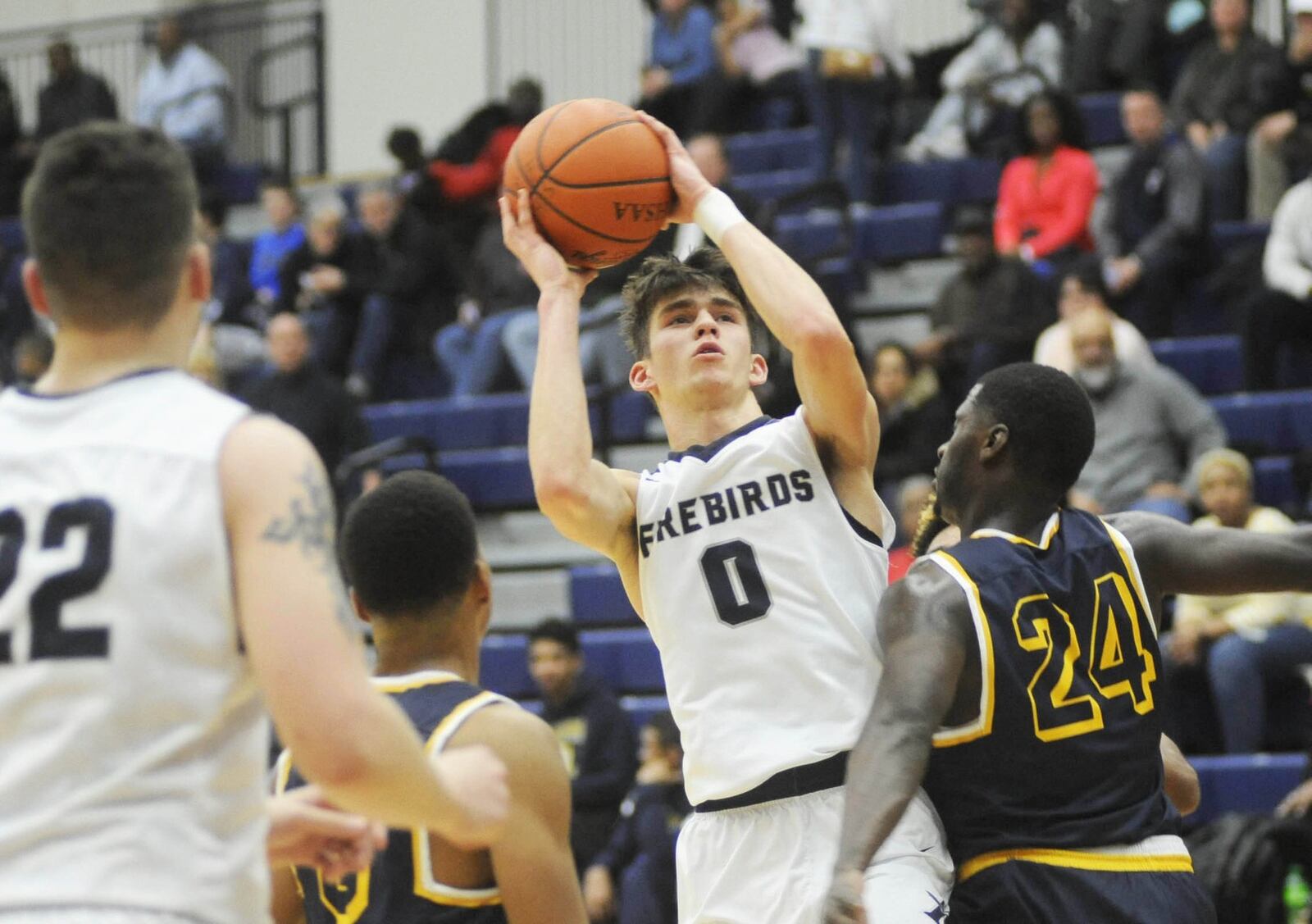 Fairmont’s Ryan Hall fires over Derrick Robinson. Springfield defeated host Fairmont 81-65 in a boys high school basketball game at Trent Arena on Fri., Jan. 19, 2018. MARC PENDLETON / STAFF