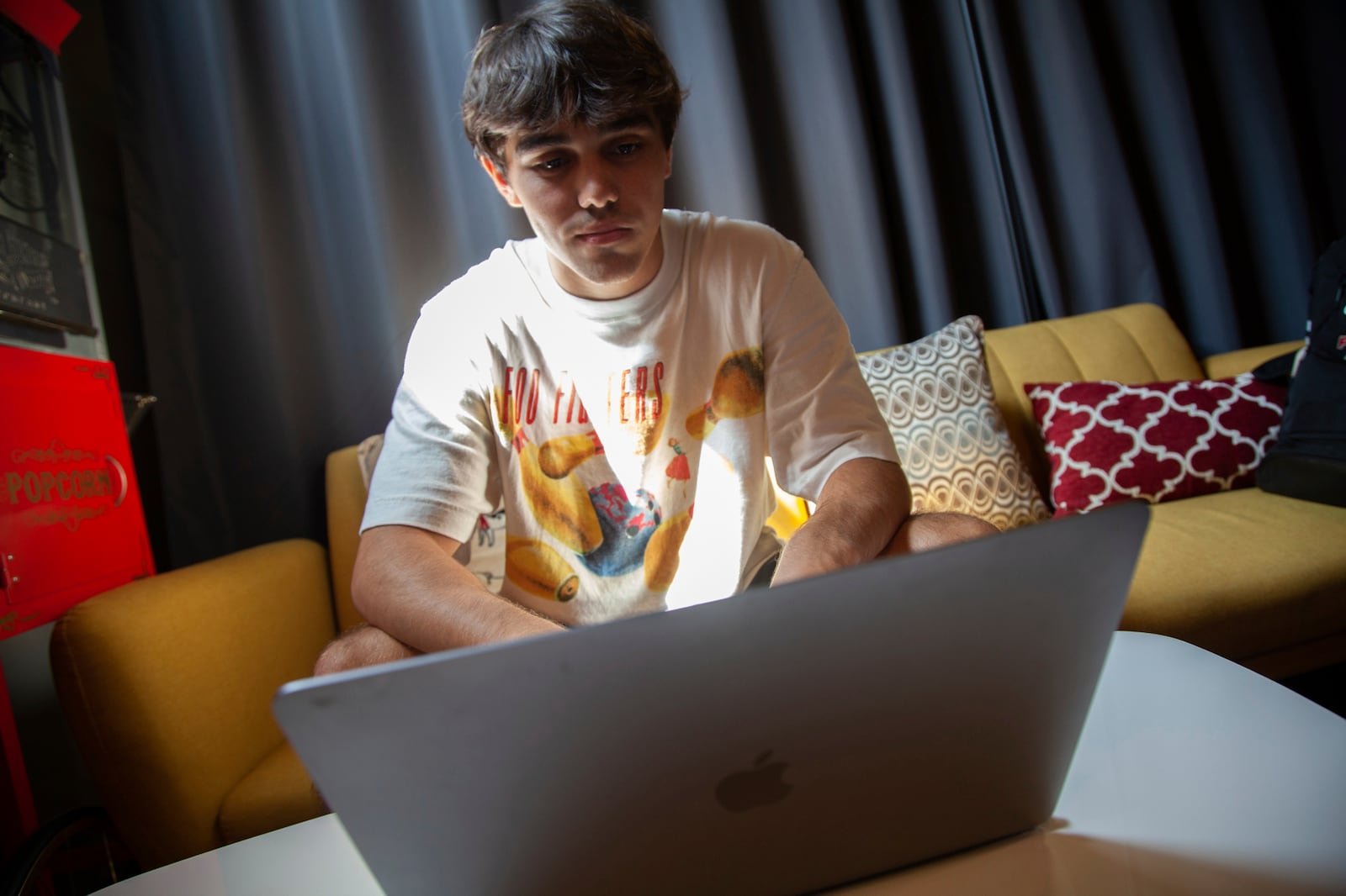 Bruce Perry, 17, demonstrates using artificial intelligence software on his laptop during a break from summer camp Tuesday, July 15, 2025, in Russellville, Ark. (AP Photo/Katie Adkins)