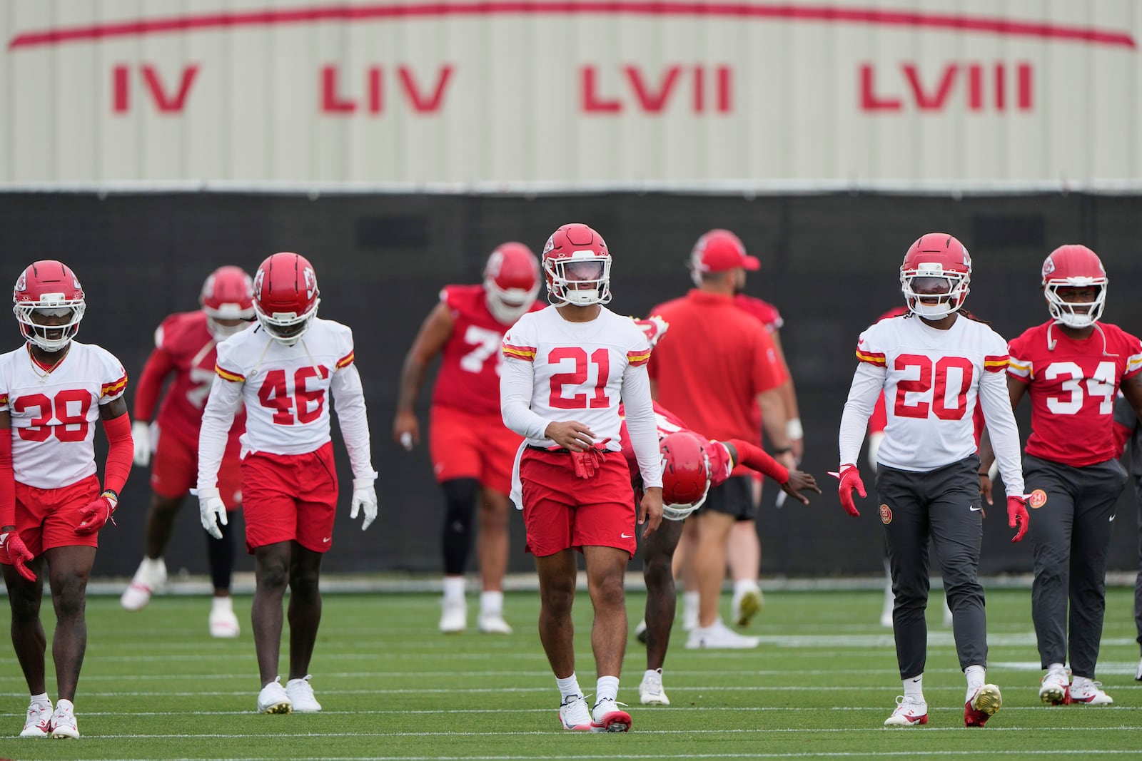 Kansas City Chiefs players warm up before the NFL football team's practice Tuesday, June 17, 2025, in Kansas City, Mo. (AP Photo/Charlie Riedel)