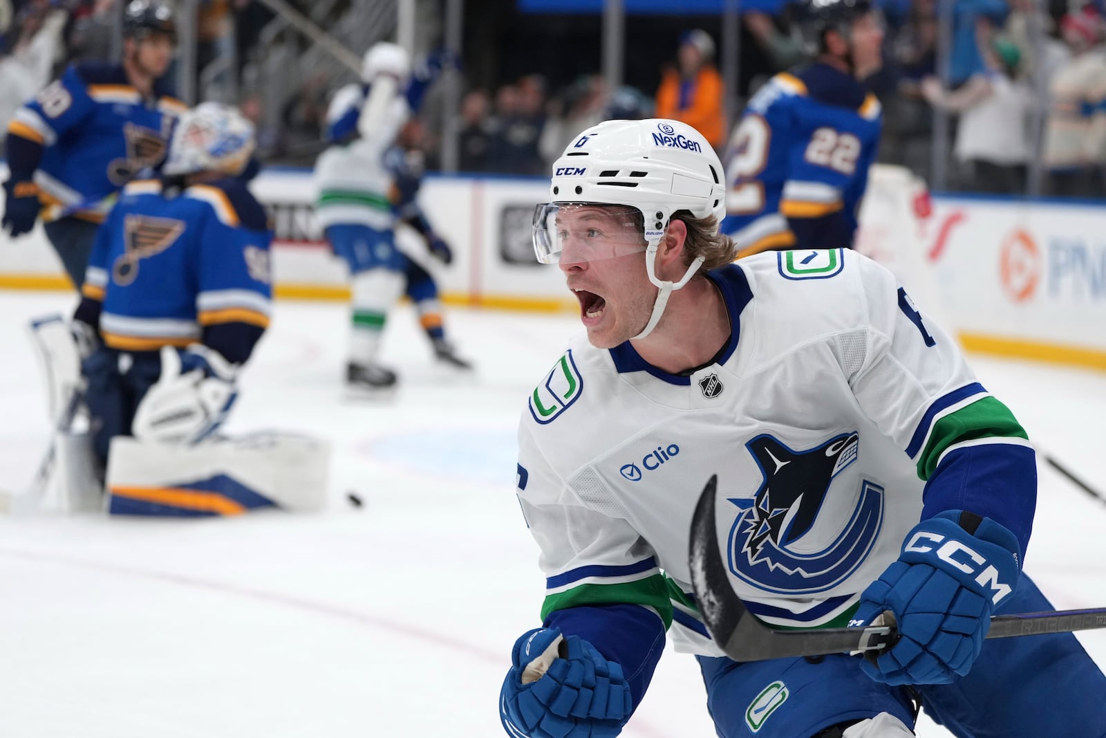 FILE - Vancouver Canucks' Brock Boeser, right, celebrates after scoring past St. Louis Blues goaltender Jordan Binnington, left, during the third period of an NHL hockey game, March 20, 2025, in St. Louis. (AP Photo/Jeff Roberson, file)