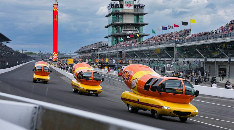FILE - Oscar Mayer Wienermobiles head into the first turn as they compete in the Wienie 500 following the practice session for the Indianapolis 500 auto race at Indianapolis Motor Speedway in Indianapolis, May 23, 2025. (AP Photo/Michael Conroy, File)