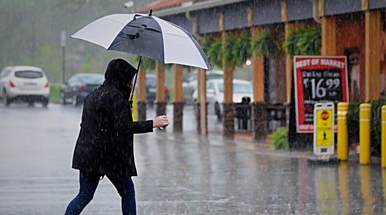 Raining at the Dorothy Lane Market in Centerville Friday morning. (Marshall Gorby/Staff)