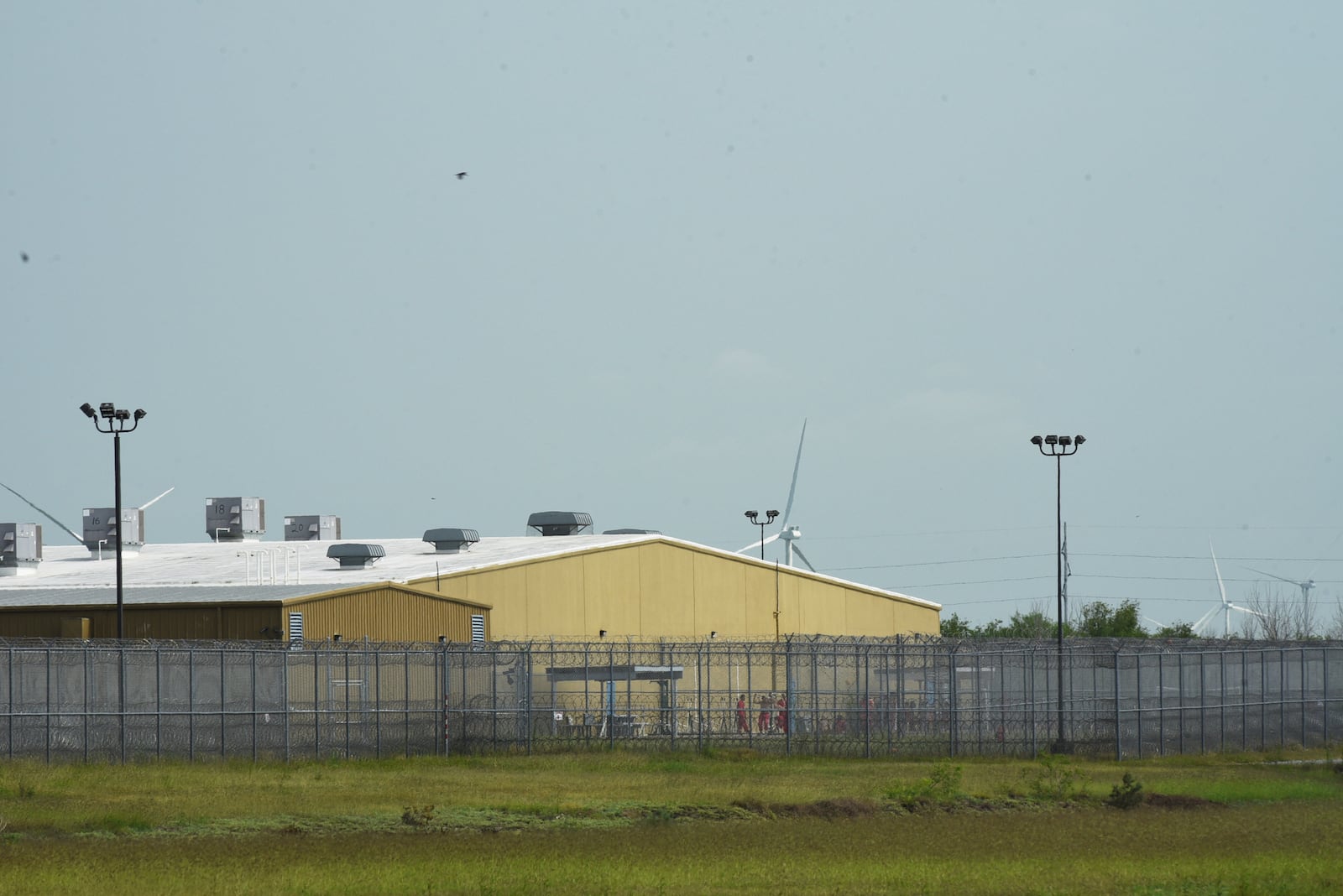 Detainees held at El Valle Detention Center in Raymondville, Texas are seen outside briefly, Thursday, May 1, 2025, after a federal judge in the district barred the Trump administration from deporting any Venezuelans from South Texas under the Alien Enemies Act, an 18th-century wartime law. (AP Photo/Valerie Gonzalez)