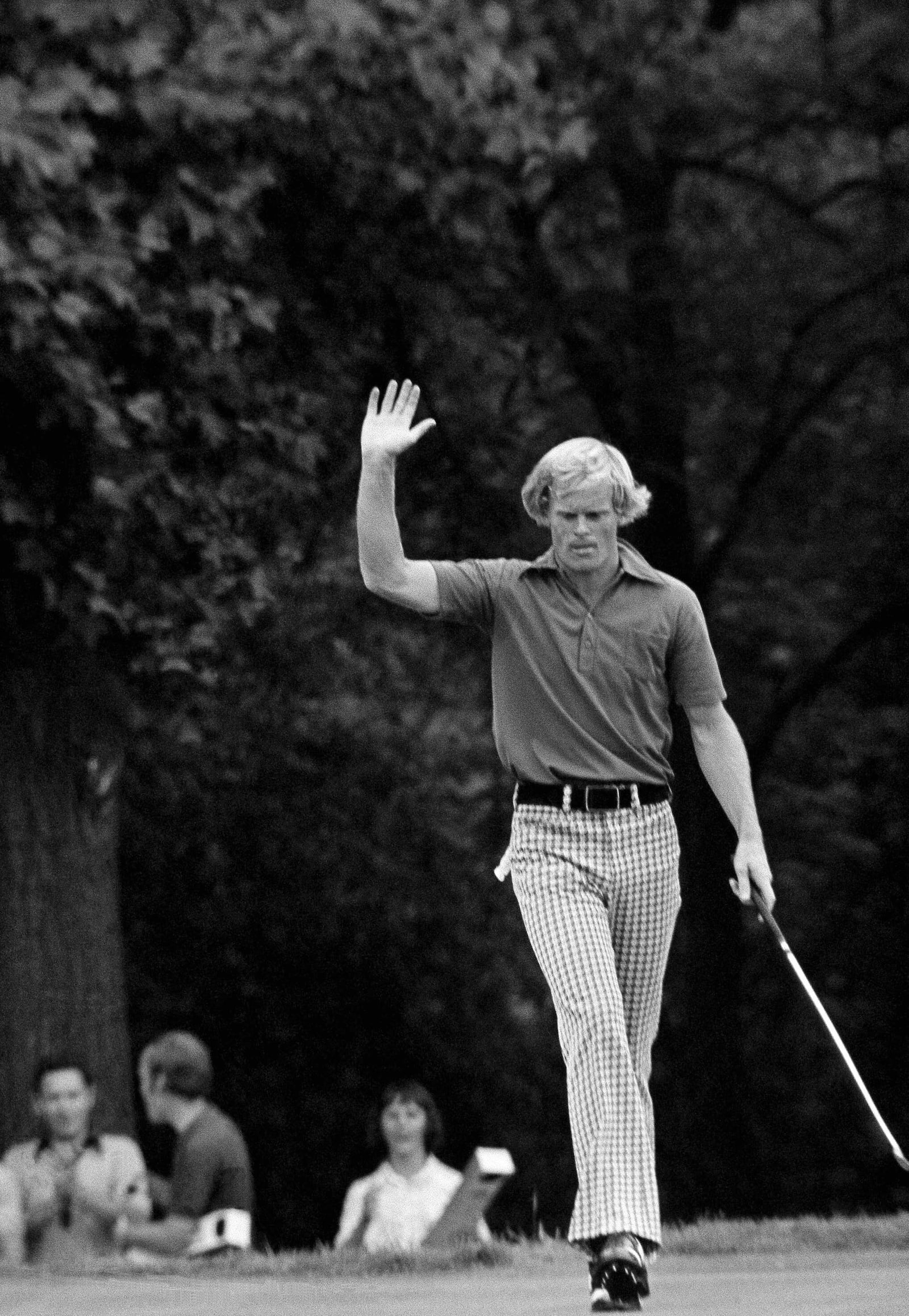 FILE - Johnny Miller, of Hilton Head Island S.C., who started his final Open round Sunday, June 17, 1973 six strokes behind the leaders and 3-over par 216, takes over fourth round lead with a charging 5-under par by birdie on the 15th, where he raises his hand after sinking the putt in Oakmont, Pa. (AP Photo, file)