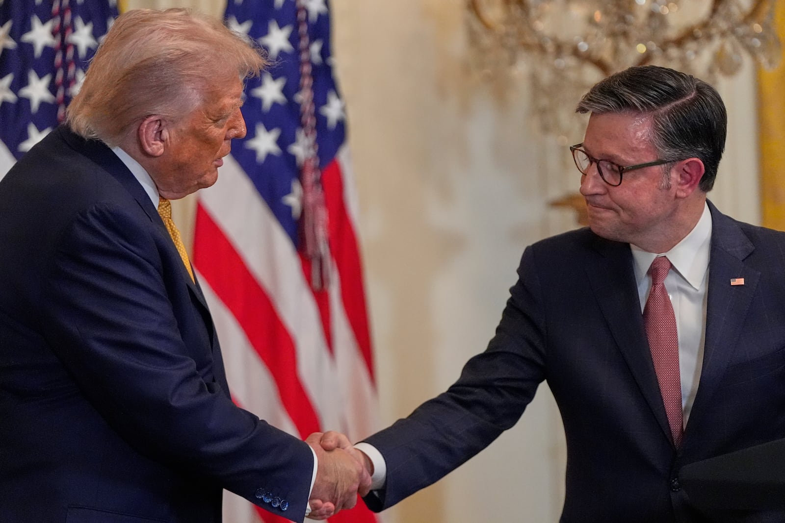 President Donald Trump shakes hands with House Speaker Mike Johnson of La., during a reception for Republican members of Congress in the East Room of the White House, Tuesday, July 22, 2025, in Washington. (AP Photo/Julia Demaree Nikhinson)