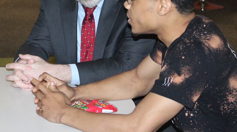 State Superintendent of Public Instruction Paolo DeMaria (left) listens to Darius Watkins discuss the impact of Springfield’s Career ConnectED on his education. JEFF GUERINI/STAFF