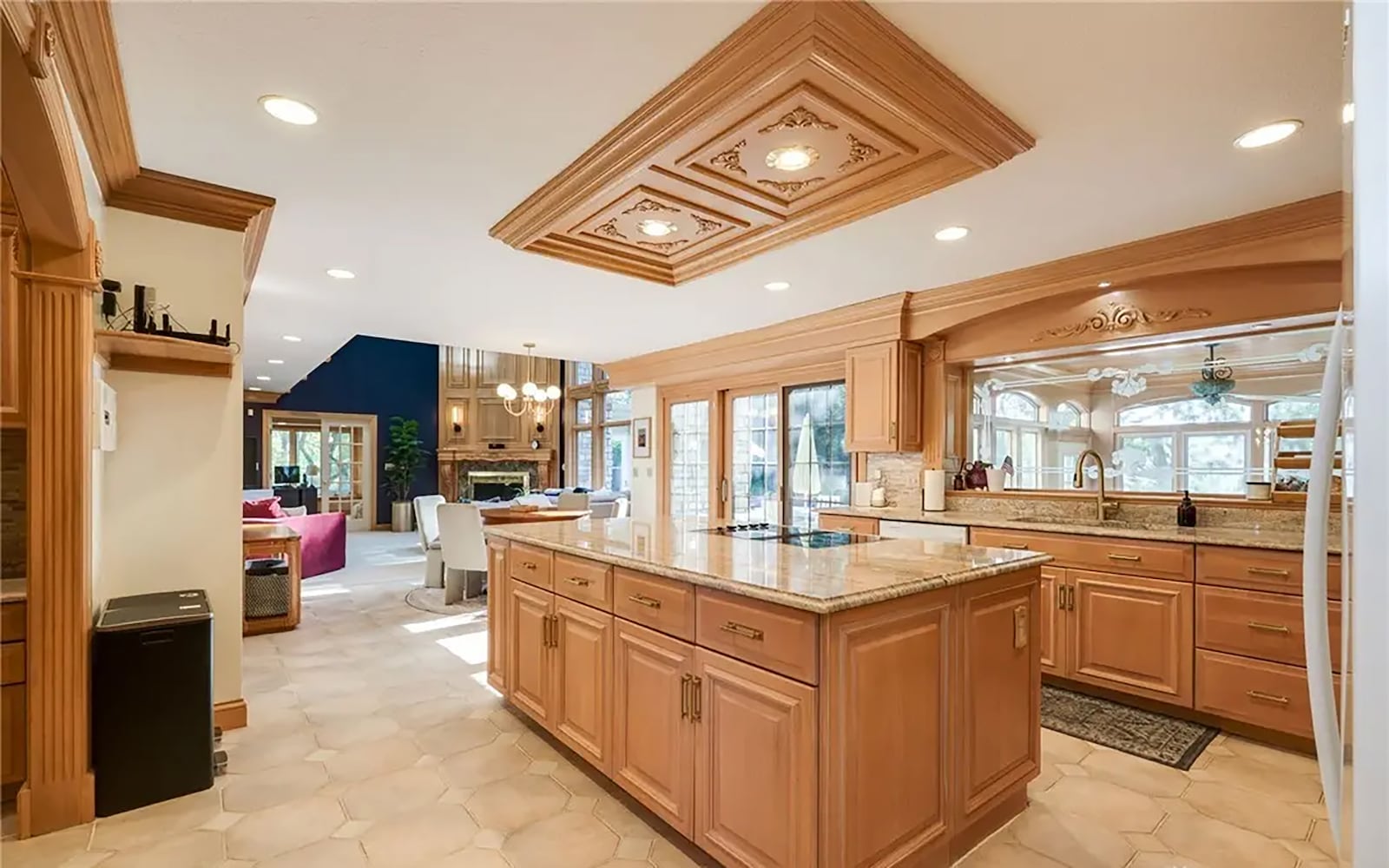 The eat in kitchen has tile flooring, custom wood cabinets with granite tops and recessed lighting. There are professional grade appliances and a breakfast nook with sliding glass doors opening to the back patio. CONTRIBUTED