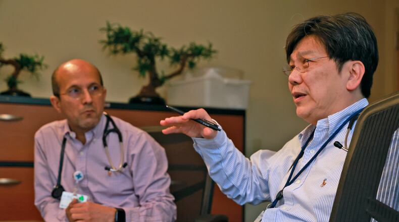Dr. Filix Kencana (right) and Dr. Zaw Bo (left) talk about lung cancer screenings at Mercy Health - Springfield's cancer center Thursday, Nov. 14, 2024. BILL LACKEY/STAFF