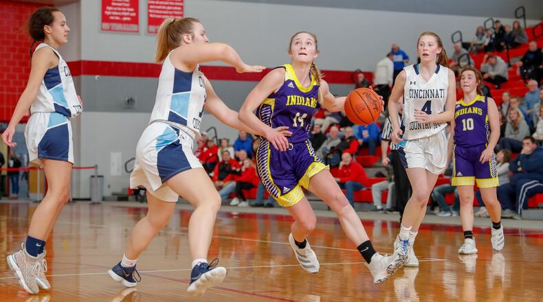 Mechanicsburg High School senior Kasey Schipfer dribbles through multiple Cincinnati Country Day as she looks to shoot the ball during their Division IV district final game on Saturday afternoon at Troy High School. Cincinnati Country Day won 56-46. CONTRIBUTED PHOTO BY MICHAEL COOPER