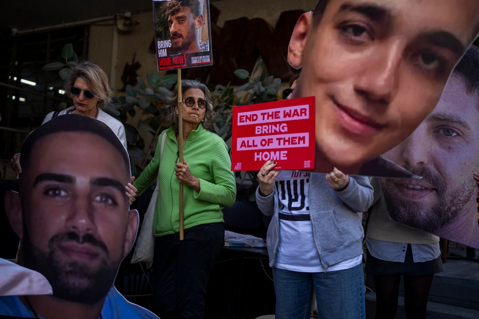Demonstrators hold photos depicting the faces of Israeli hostages who are being held in the Gaza Strip, during a protest demanding their release from Hamas captivity, in Tel Aviv, Israel, Thursday, March 6, 2025. (AP Photo/Oded Balilty)