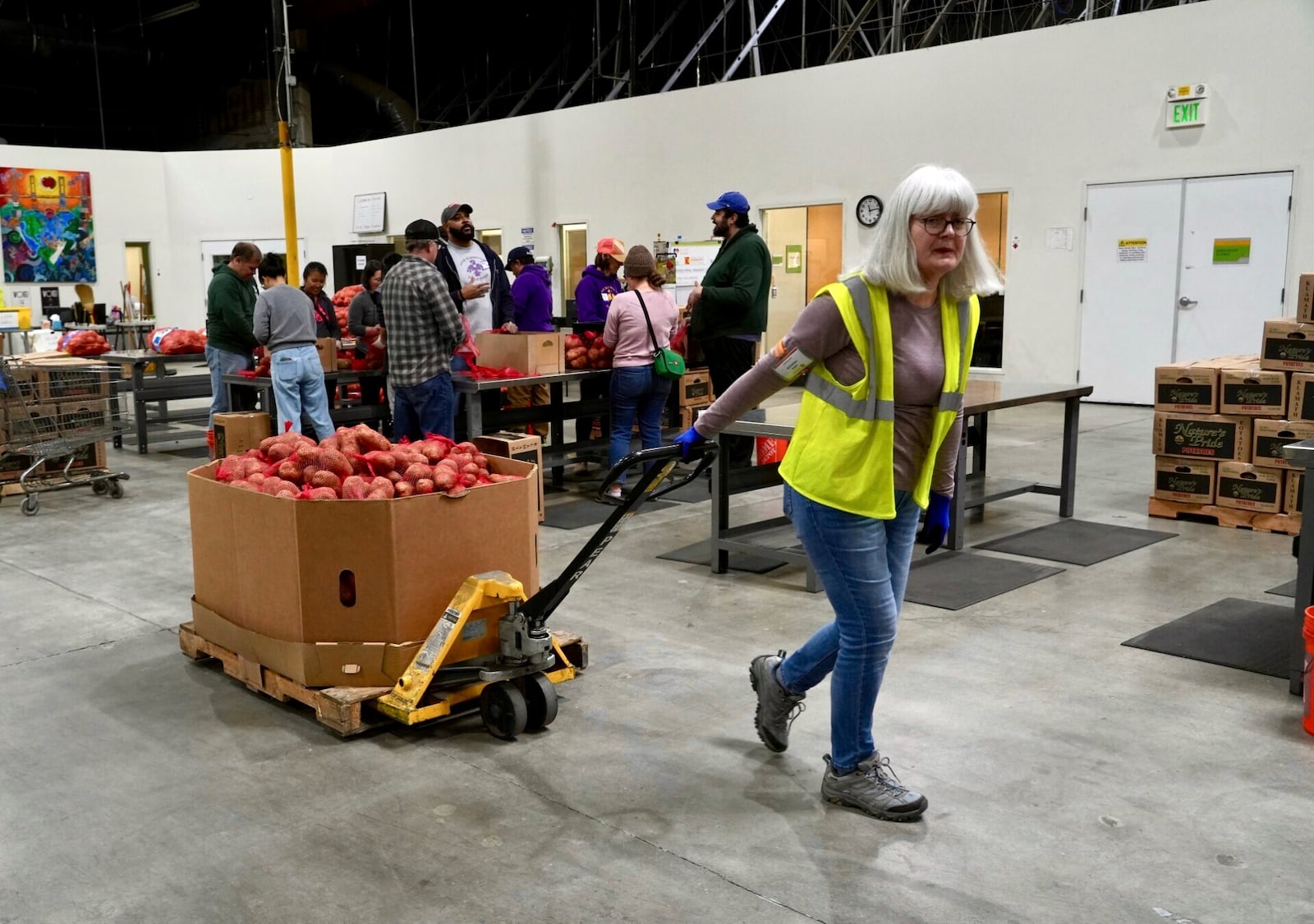 A volunteer pulls box of produce at the Alameda County Community Food Bank in Alameda, Calif., on Friday, April 25, 2025. (AP Photo/Terry Chea)