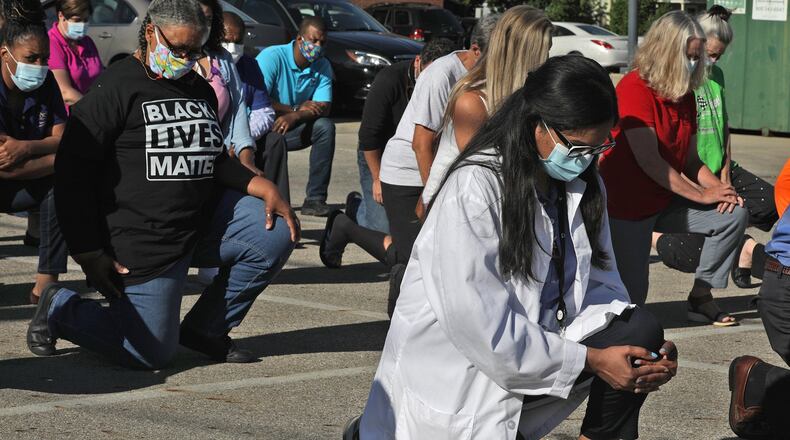 The staff and supporters of the Rocking Horse Center took a knee in the center’s parking lot Friday at 8:46 a.m. to show support for the Black Lives Matter movement. BILL LACKEY/STAFF