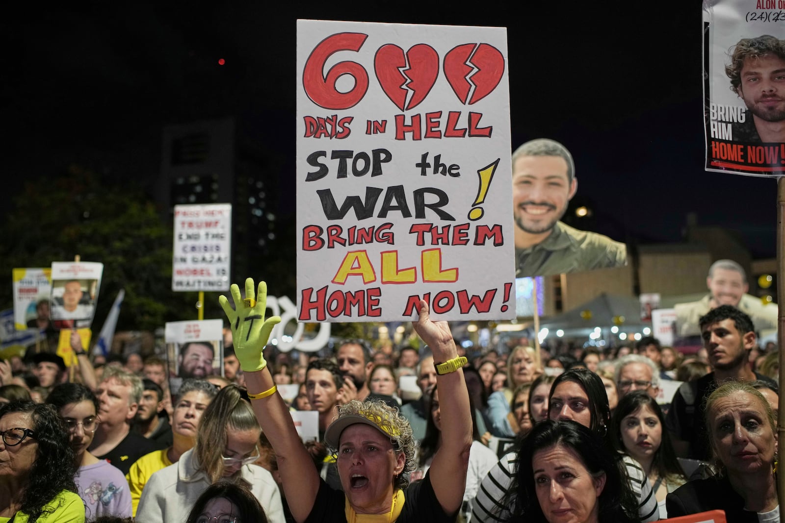 People attend a rally marking 600 days since Israelis were taken hostage by Hamas in Gaza, demanding their release and an end to the war, at a plaza known as the hostages square in Tel Aviv, Israel, Wednesday, May 28, 2025. (AP Photo/Leo Correa)