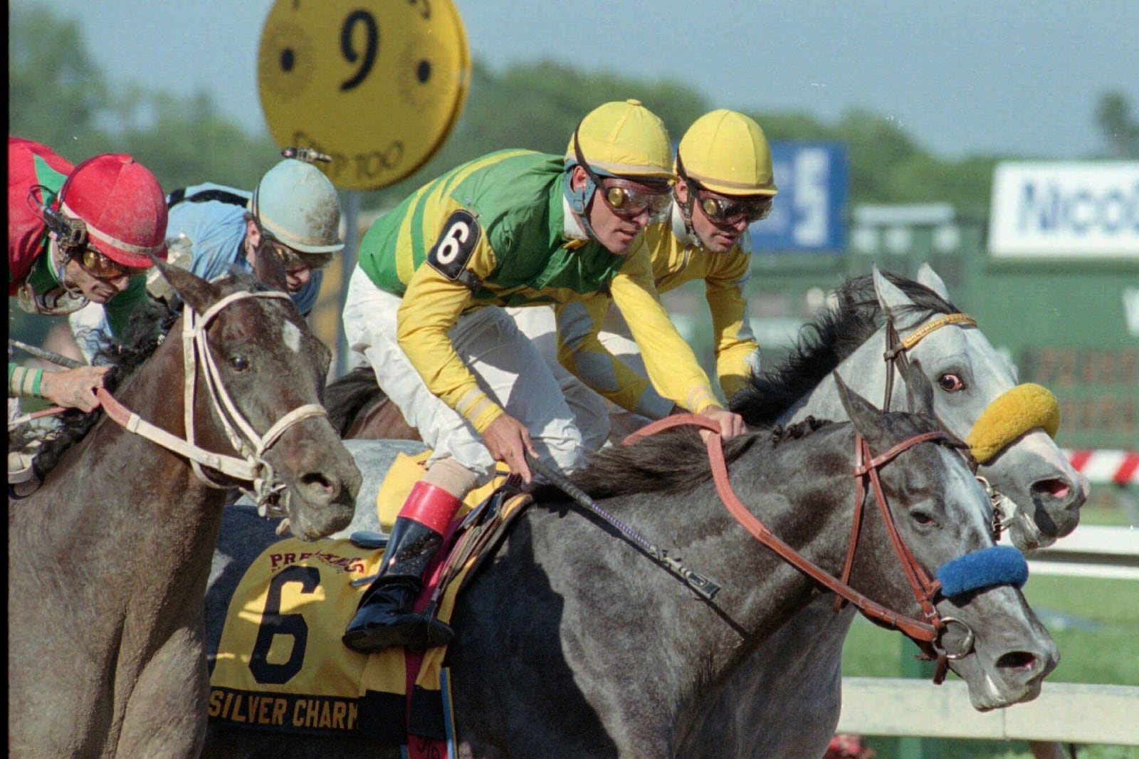 FILE - Jockey Gary Stevens is up in the stirrups of Silver Charm just past the finish line after beating out Captain Bodgit, left, with Alex Solis up, and Free House, right rear, with Paco Gonzalez up, to win the 122nd running of the Preakness Stakes horse race, Saturday, May 17, 1997, at Pimlico Race Course in Baltimore. (AP Photo/Steve Nesius File)