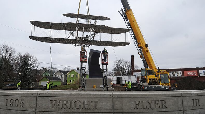 The Wright Flyer III sculpture was put in place Tuesday morning Feb. 28, 2023, at Edwin C. Moses Boulevard and West Third Street. The Wright Flyer III artwork was on display in downtown Dayton on East Monument Avenue for about two decades before it was removed in summer 2020. MARSHALL GORBY\STAFF