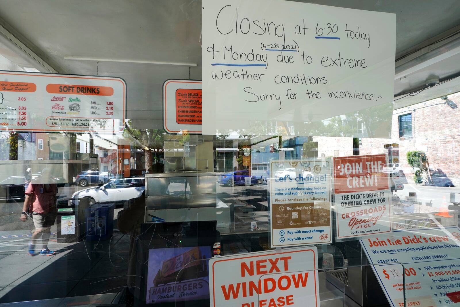 FILE - A sign in the window of the Dick's Drive-In posted due to excessive heat in Seattle's Capitol Hill neighborhood is shown Monday, June 28, 2021, in Seattle. (AP Photo/Ted S. Warren, File)