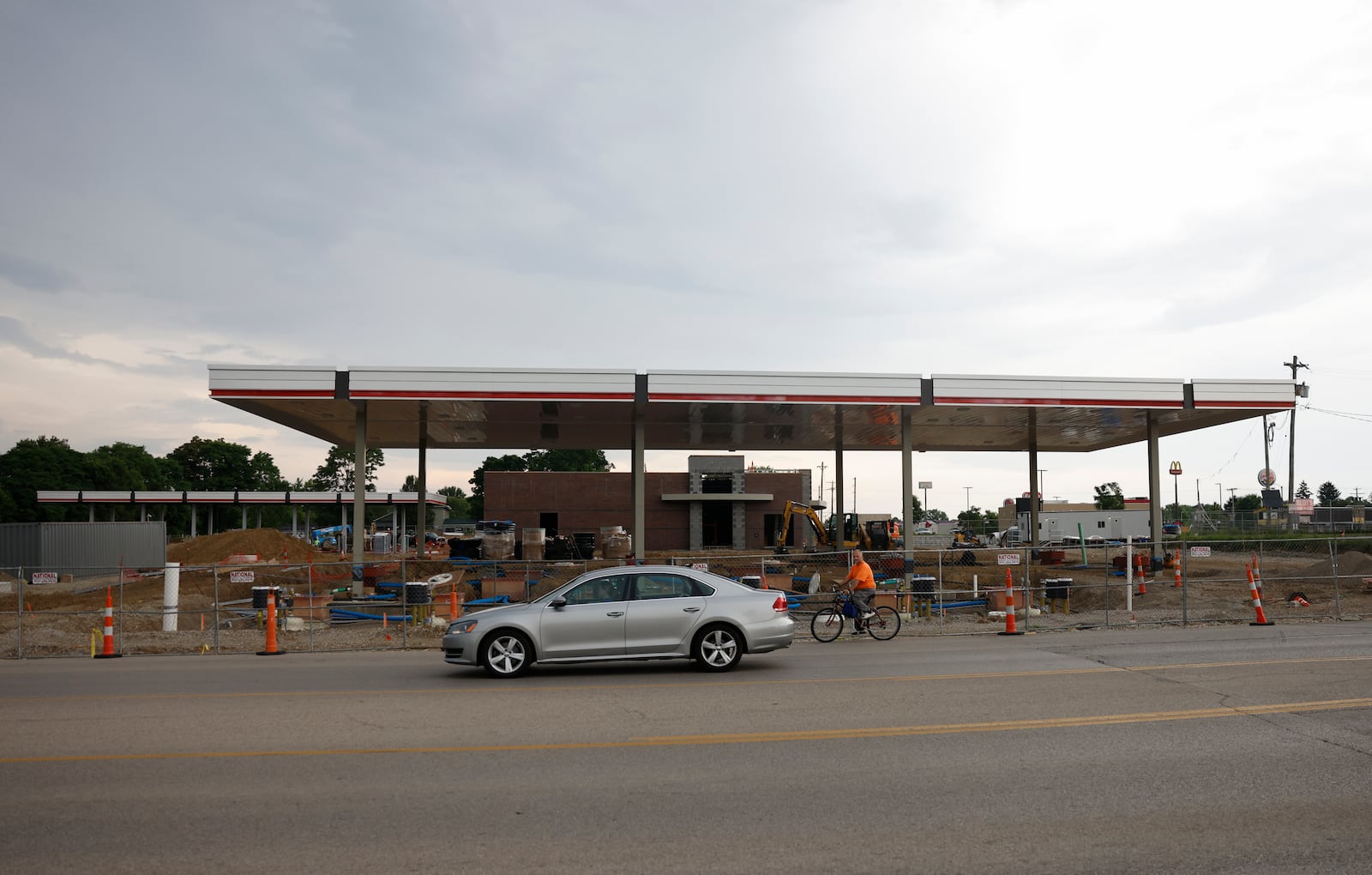 A car and bicyclist travel past a QuikTrip gas station under construction on West Leffel Lane on Thursday, June 26, 2025, in Springfield. JOSEPH COOKE/STAFF