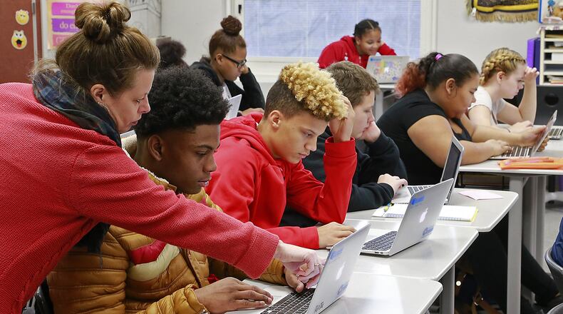 Springfield High School teacher, Heather Turner, helps Trevor Crockran with a problem on his laptop in class. Bill Lackey/Staff