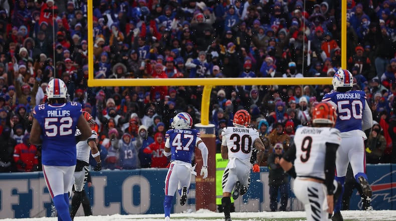 Buffalo Bills cornerback Christian Benford (47) runs for a touchdown after intercepting a pass by Cincinnati Bengals quarterback Joe Burrow (9) during the second half of an NFL football game, Sunday, Dec. 7, 2025, in Orchard Park, N.Y. Also seen are Buffalo Bills defensive tackle Jordan Phillips (52), Cincinnati Bengals running back Chase Brown (30) and Buffalo Bills defensive end Greg Rousseau (50). (AP Photo/Jeffrey T. Barnes)