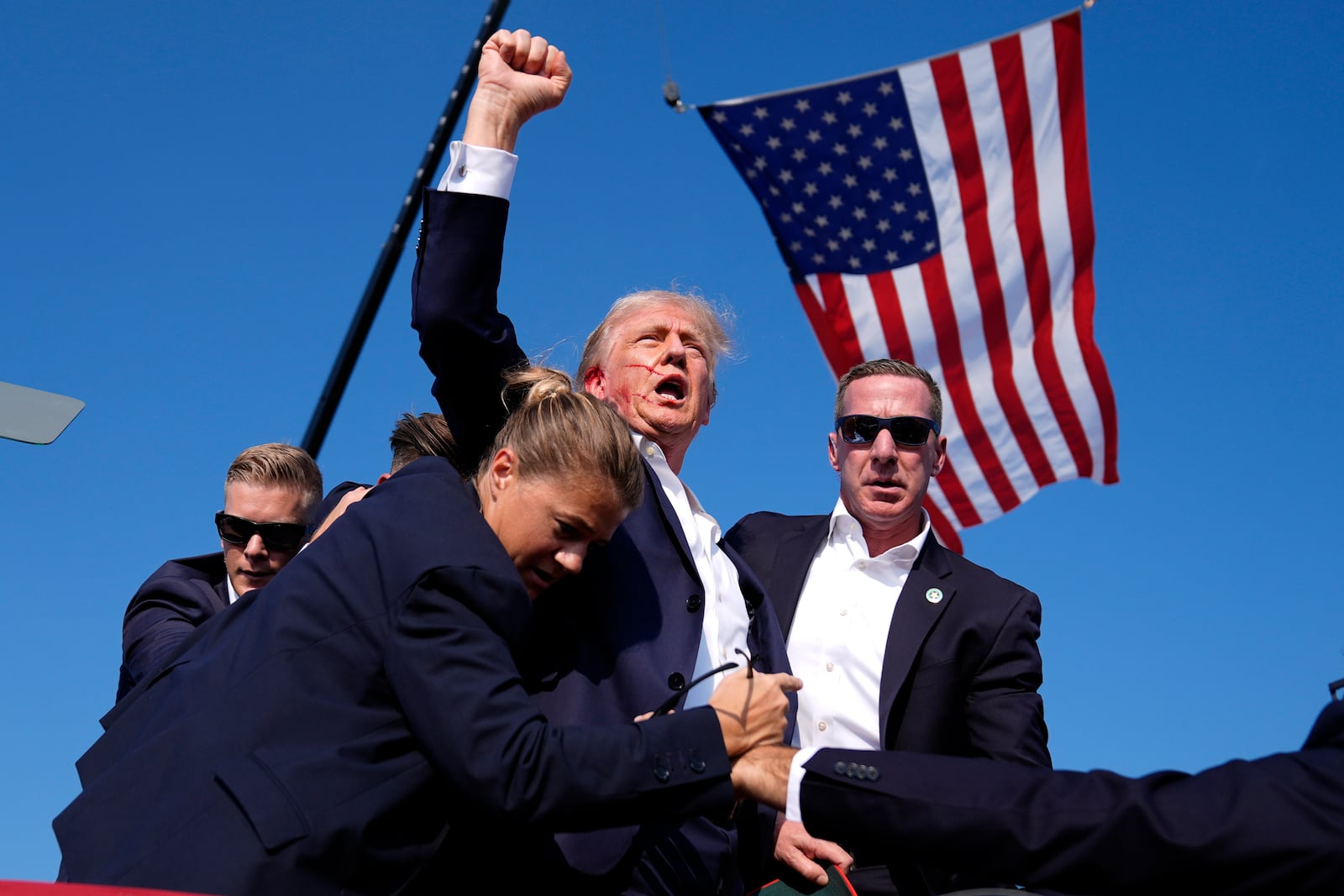 FILE - Republican presidential candidate former President Donald Trump is surrounded by U.S. Secret Service agents after an assassination attempt at a campaign rally in Butler, Pa., Saturday, July 13, 2024. (AP Photo/Evan Vucci, File)