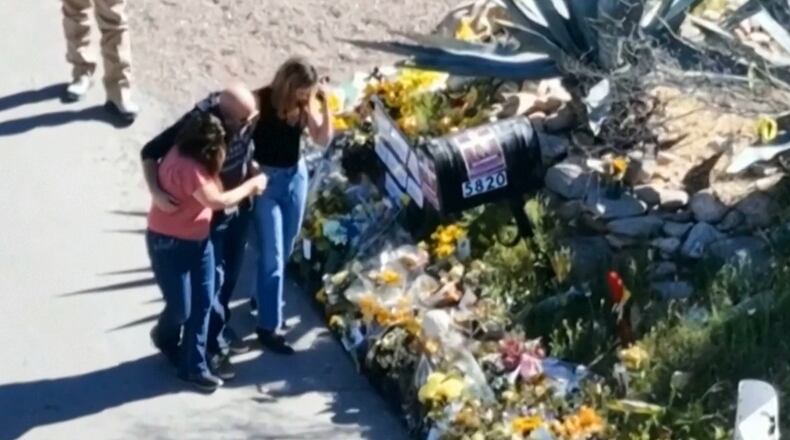 This image made from video provided by FOX News Digital shows Savannah Guthrie, right, her sister Annie Guthrie, left, and her brother-in-law Tommaso Cioni, Monday, March 2, 2026, visiting a tribute to their mother Nancy Guthrie. (FOX News Digital via AP)