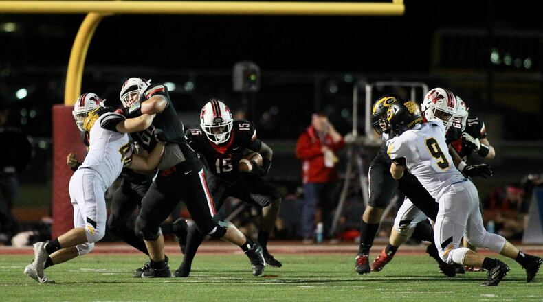Wayne's Joshua Padilla, left, blocks for Tyler Dorsey (15) during a game against Centerville on Oct. 9, 2020, in Huber Heights. David Jablonski/Staff