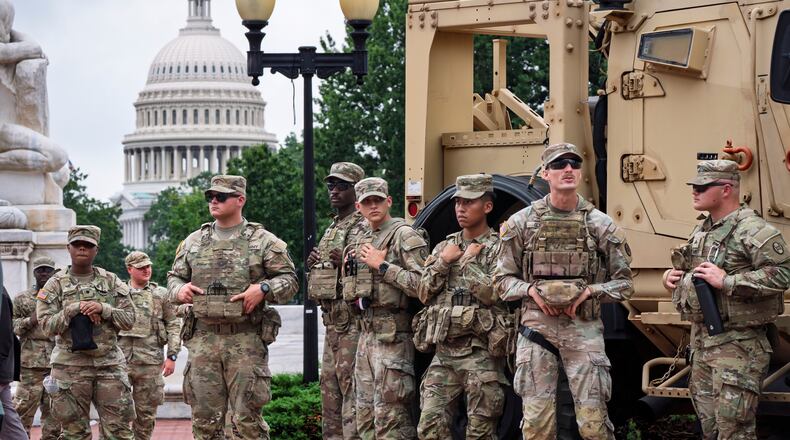 FILE - National Guard troops congregate at the entrance to Union Station in Washington, Aug. 20, 2025. (AP Photo/J. Scott Applewhite, FIle)