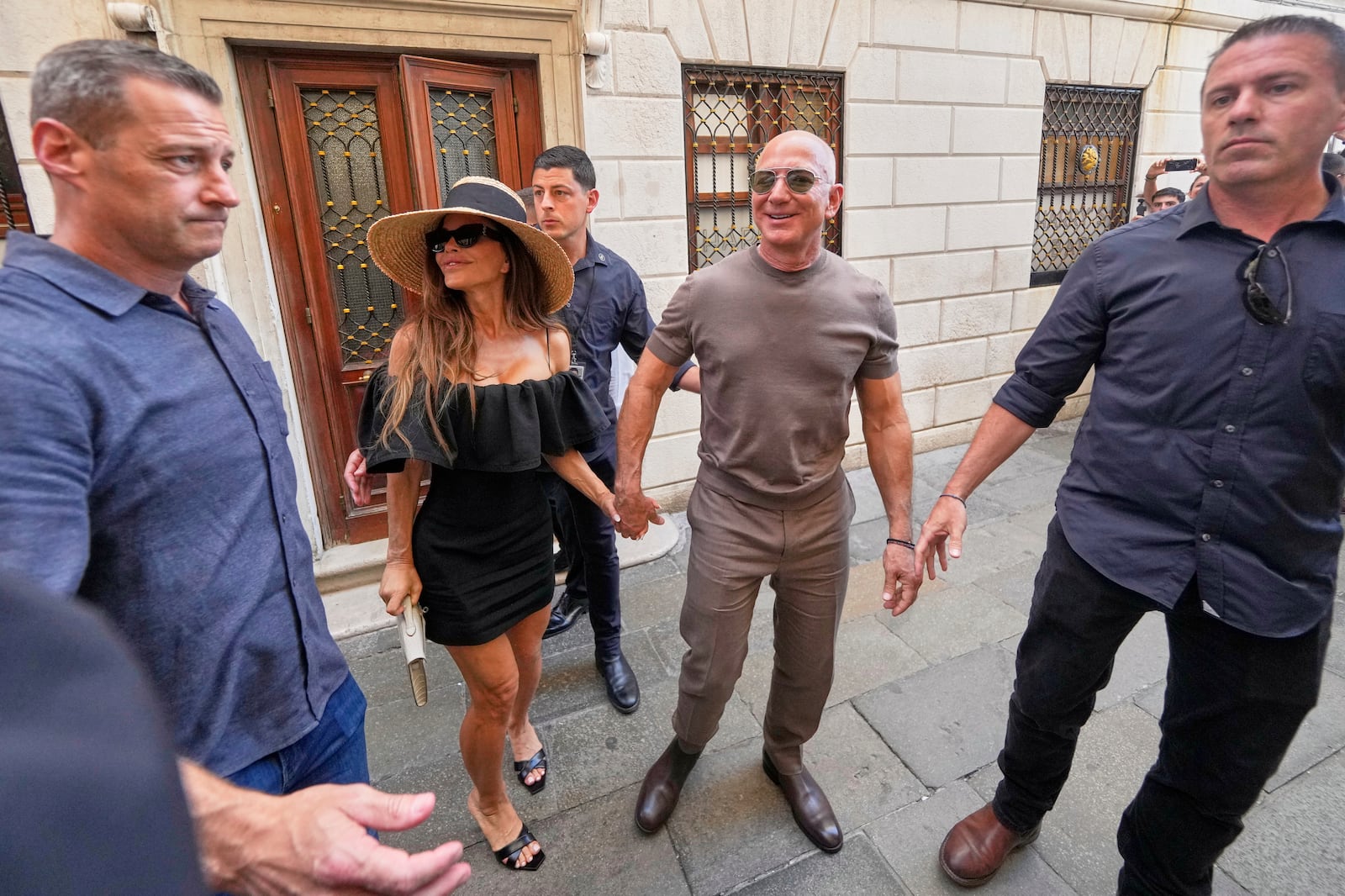Lauren Sanchez Bezos and Jeff Bezos leave the Harry's Bar in Venice, Italy, Saturday,June 28, 2025, the day after their wedding. (AP Photo/Luca Bruno)