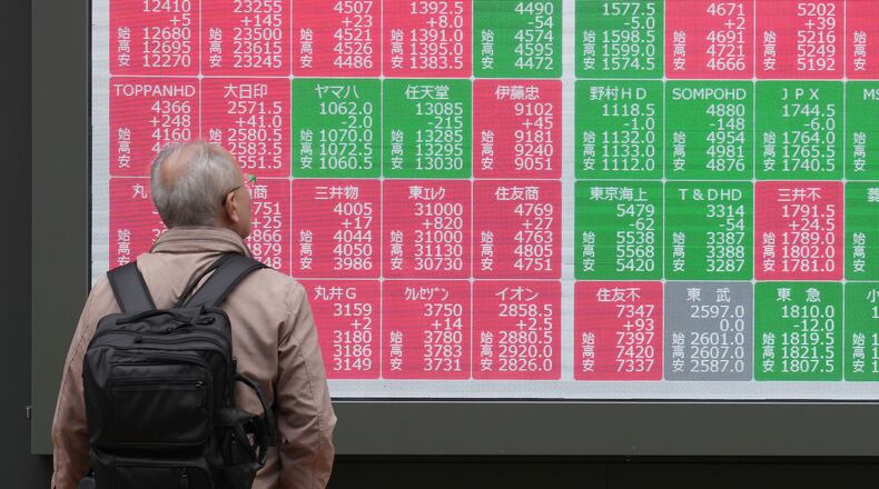 A person looks at an electronic stock board showing Japan's Nikkei index at a securities firm Tuesday, Nov. 25, 2025, in Tokyo. (AP Photo/Eugene Hoshiko)