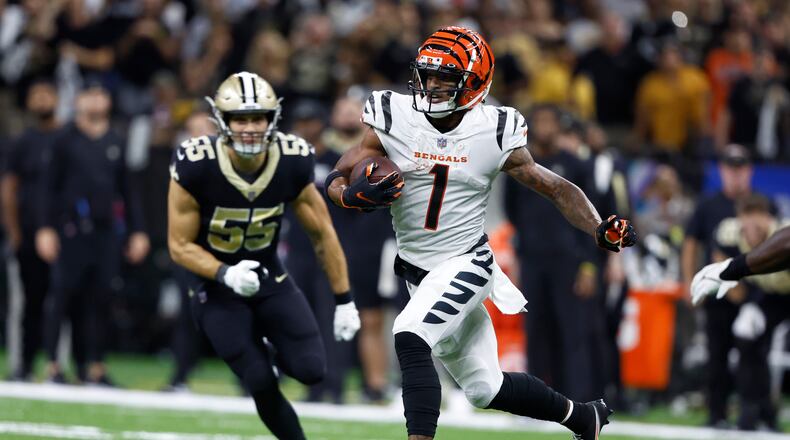 Cincinnati Bengals wide receiver Ja'Marr Chase (1) runs past New Orleans Saints linebacker Kaden Elliss (55) during the second half of an NFL football game in New Orleans, Sunday, Oct. 16, 2022. (AP Photo/Butch Dill)