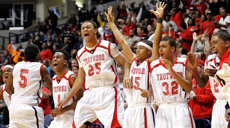 Trotwood-Madison’s bench celebrates a game-tying shot in the fourth-quarter of Friday night’s OHSAA Regional Final game against Moeller at Xavier University’s Cintas Center Friday, March 14, 2014, in Cincinnati. NICK DAGGY / STAFF