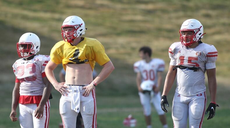Wittenberg players, including Bobby Froehlich, center, get ready for a snap during practice on Wednesday, Aug. 21, 2019, in Springfield. David Jablonski/Staff