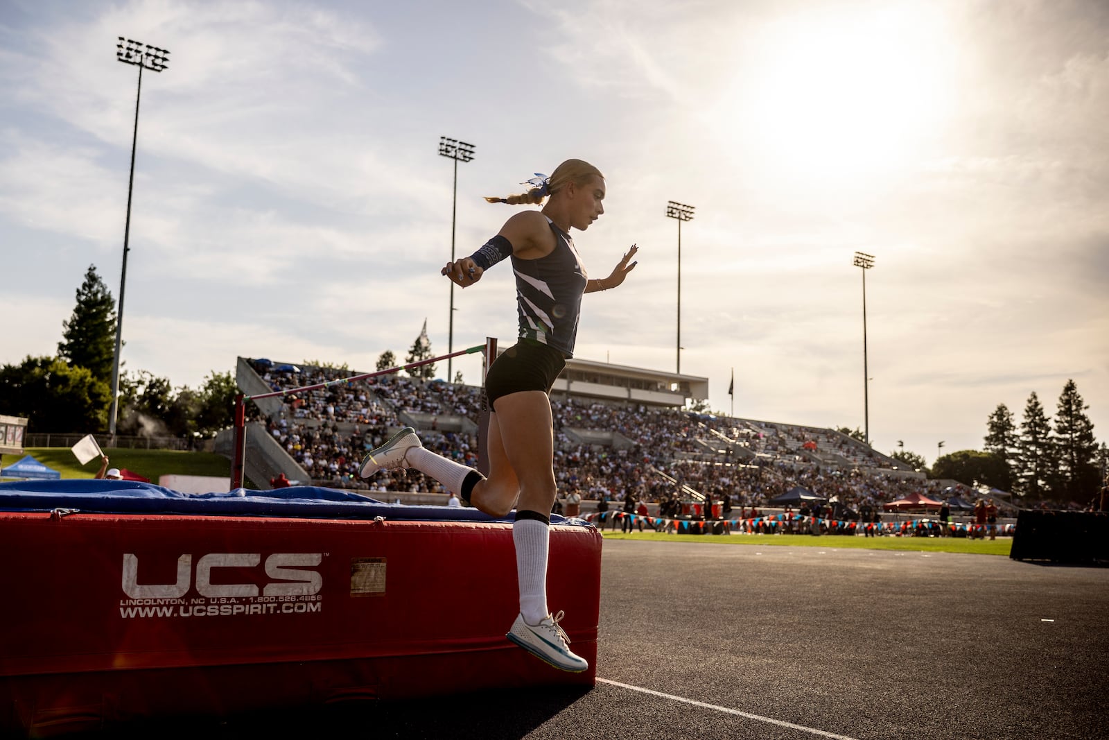 AB Hernandez, a transgender student at Jurupa Valley High School, leaps off the crash pad while competing in high jump at the California high school track-and-field championships in Clovis, Calif., Saturday, May 31, 2025. (Stephen Lam/San Francisco Chronicle via AP)