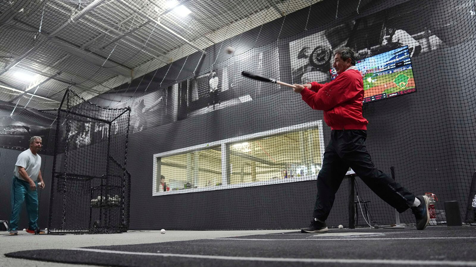 Customers Ed Costantini, right, and Jack Bradley try a torpedo baseball bat at Victus Sports in King of Prussia, Pa., Wednesday, April 2, 2025. (AP Photo/Matt Rourke)