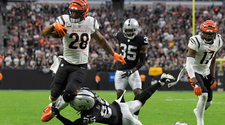 Cincinnati Bengals running back Joe Mixon (28) runs for a touchdown against Las Vegas Raiders free safety Trevon Moehrig (25) during the first half of an NFL football game, Sunday, Nov. 21, 2021, in Las Vegas. (AP Photo/David Becker)
