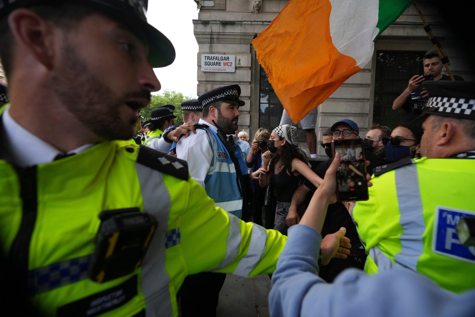 Police and demonstrators confront each other during a protest by Palestine Action group in London, Monday, June 23, 2025. (AP Photo/Frank Augstein)