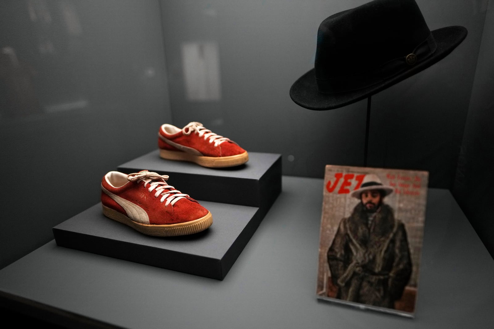 PUMA sneakers and a hat worn by Walt Frazier are displayed at the Metropolitan Museum of Art's Costume Institute exhibition, "Superfine: Tailoring Black Style," on Saturday, May 3, 2025, in New York. (Photo by Charles Sykes/Invision/AP)